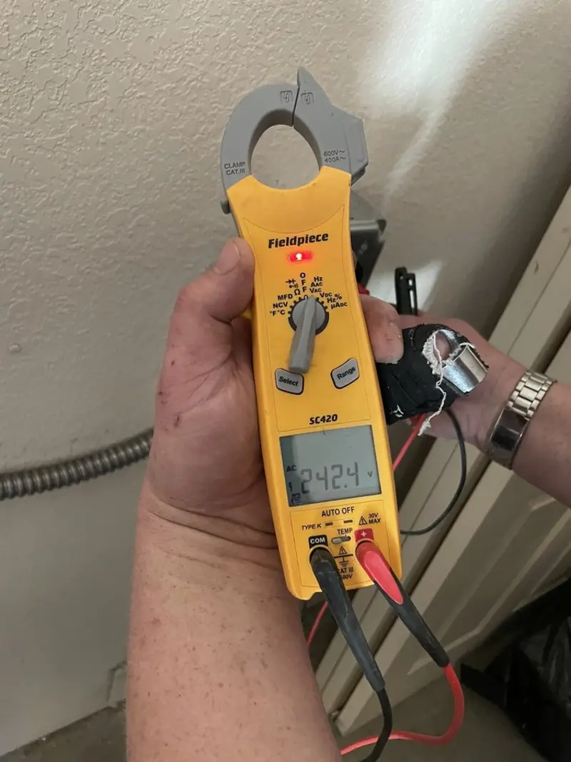 Voltage testing with clamp meter during Whole House Surge Protector in Cicero